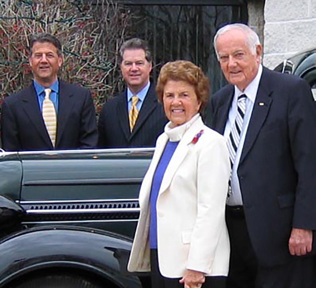 Ed Herr, J.M. Herr, and J.S. Herr with Miriam standing outside of a car